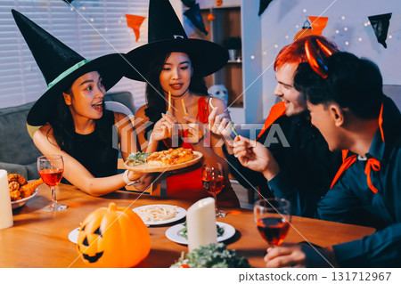 Joyful office Halloween party with coworkers in costumes, celebrating with drinks and laughter, fostering teamwork and festive spirit 131712967