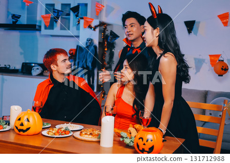 Joyful office Halloween party with coworkers in costumes, celebrating with drinks and laughter, fostering teamwork and festive spirit 131712988