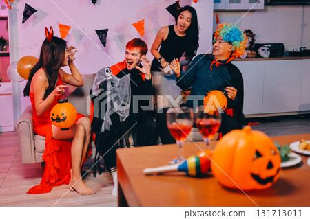 Joyful office Halloween party with coworkers in costumes, celebrating with drinks and laughter, fostering teamwork and festive spirit Joyful office Halloween party with coworkers in costumes, celebrating with drinks and laughter, fostering teamwork and festive spirit 131713011