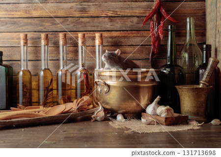 Rat on a table with old kitchen utensils. Rat on a table with old kitchen utensils. 131713698