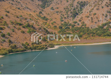 Hidden mountain lake with calm turquoise water red rocks and green trees. Hidden mountain lake with calm turquoise water red rocks and green trees. 131714744
