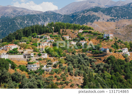 Mountain village Lakkoi in western Crete surrounded by pine forest on sunny day. 131714865