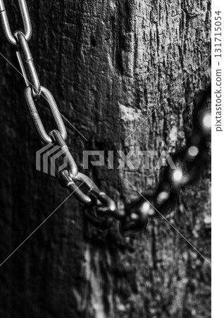 The chain with a dark shine is set against a neutral background The chain with a dark shine is set against a neutral background 131715054