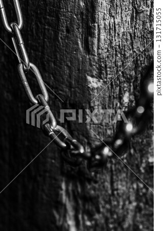 The chain with a dark shine is set against a neutral background The chain with a dark shine is set against a neutral background 131715055