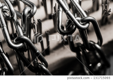 The metal chain is shot in close-up with the emphasis on the links The metal chain is shot in close-up with the emphasis on the links 131715093