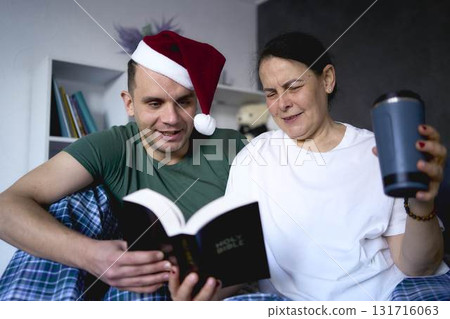 a senior woman and young man read the Bible together, celebrate Christmas, online church a senior woman and young man read the Bible together, celebrate Christmas, online church 131716063