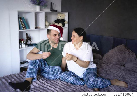 a senior woman and young man congratulate everyone on Christmas via the Internet, video conference, celebration at home a senior woman and young man congratulate everyone on Christmas via the Internet, video conference, celebration at home 131716064