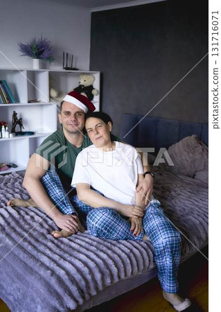 a          senior woman and young man hugging on bed 131716071