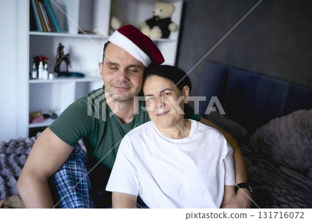 a          senior woman and young man hugging on bed 131716072