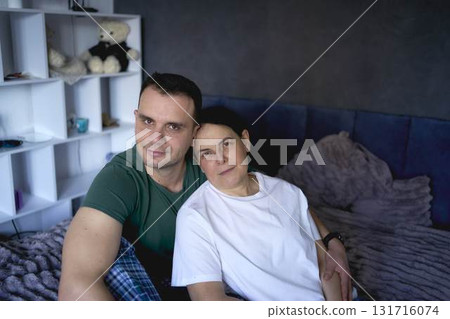 a senior woman and young man hugging on bed a senior woman and young man hugging on bed 131716074