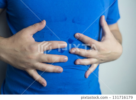 A man suffers from palmar hyperhidrosis. He wipes his sweaty palms due to excessive sweating. Treatment of hyperhidrosis with botulinum toxin injection into the hand. A man suffers from palmar hyperhidrosis. He wipes his sweaty palms due to excessive sweating. Treatment of hyperhidrosis with botulinum toxin injection into the hand. 131716179
