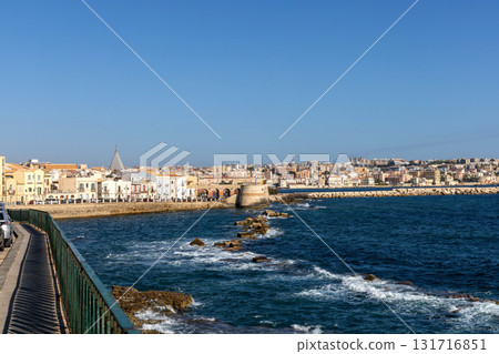 Sunlit Syracuse buildings along Mediterranean harbor coast Sunlit Syracuse buildings along Mediterranean harbor coast 131716851