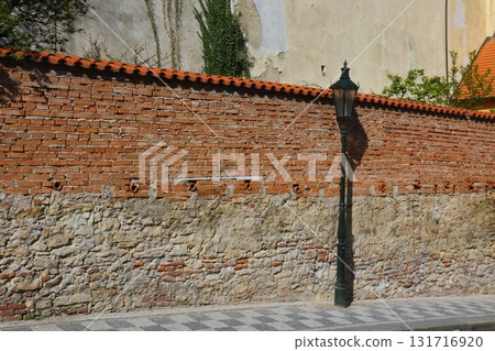 Brick wall and street lamp, Prague 131716920