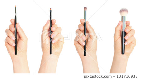 Set of hands holding cosmetic brushes isolated on transparent background 131716935