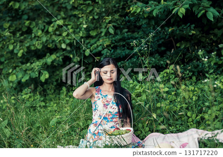 A beautiful girl at a picnic in the forest 131717220