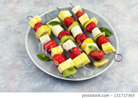 Colorful fruit skewers. 131717363