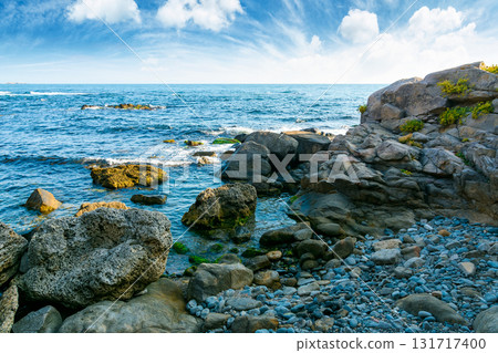 weekend on a rocky beach at the black sea under open blue sky. beautiful coastline of bulgaria in summer. seascape scenery on a bright morning with clouds above horizon. sunny weather weekend on a rocky beach at the black sea under open blue sky. beautiful coastline of bulgaria in summer. seascape scenery on a bright morning with clouds above horizon. sunny weather 131717400