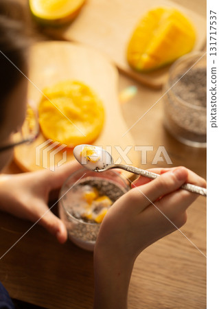 Mango chia pudding with coconut milk served in glass 131717537