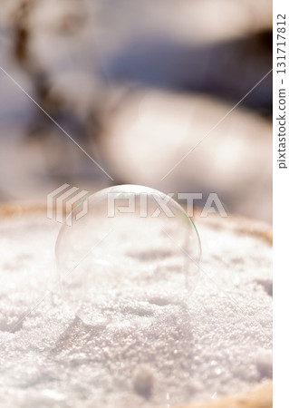 Delicate frozen soap bubble on winter snow surface 131717812