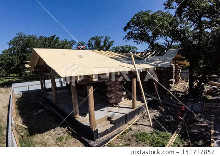 Stage of construction of a wooden house. Stage of construction of a wooden house. 131717852