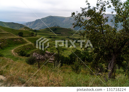 Chokhsky terraces Dagestan. Landscape of mountainous Dagestan with terraced fields and peaks mountains in the distance. Chokhsky terraces Dagestan. Landscape of mountainous Dagestan with terraced fields and peaks mountains in the distance. 131718224