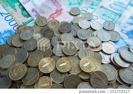 on flat surface, numerous russian coins and banknotes are arranged together. close up. 131718327