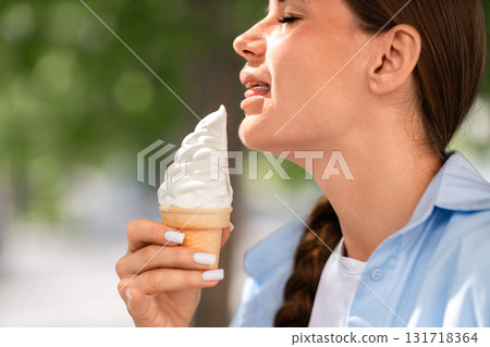 Icecream Woman Summer Taste Woman licks ice cream cone on a summer day outside to enjoy the sweet treat. Icecream Woman Summer Taste Woman licks ice cream cone on a summer day outside to enjoy the sweet treat. 131718364