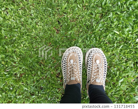 Women white sneakers on wooden background Women white sneakers on wooden background 131718455