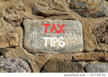 Tax tips symbol. Concept word Tax tips on beautiful grey stone on stone wall. Beautiful stone wall background. Business tax tips concept. Copy space. Tax tips symbol. Concept word Tax tips on beautiful grey stone on stone wall. Beautiful stone wall background. Business tax tips concept. Copy space. 131718710