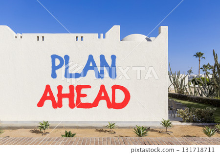 Plan ahead symbol. Concept word Plan ahead on beautiful white wall. Beautiful blue sky background. Business plan ahead concept. Copy space. 131718711