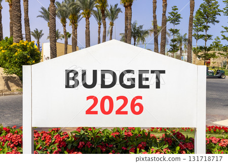 Budget 2026 symbol. Concept words Budget 2026 on beautiful white road sign. Beautiful palm trees palm-trees and blue sky background. Business and budget 2026 concept. Copy space. 131718717