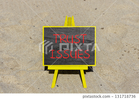 Trust issues symbol. Concept word Trust issues on beautiful black blackboard. Beautiful sand beach background. Black blackboard. Business trust issues concept. Copy space. 131718736
