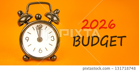 2026 Budget symbol. Concept words 2026 Budget on beautiful orange paper. Beautiful orange paper background. Beautiful black alarm clock. Business and 2026 budget concept. Copy space. 2026 Budget symbol. Concept words 2026 Budget on beautiful orange paper. Beautiful orange paper background. Beautiful black alarm clock. Business and 2026 budget concept. Copy space. 131718748