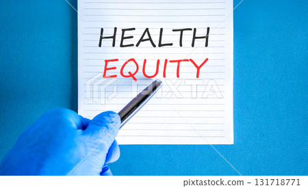 Health equity symbol. Concept words Health equity on beautiful white note. Doctor's hand in blue medical glove. Black pen. Beautiful blue background. Medical healthy lifestyle health equity concept 131718771