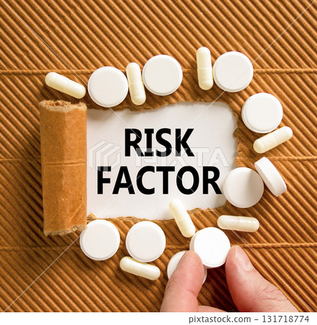 Risk factor symbol. Concept words Risk factor on beautiful white paper. White pills tablets. Doctor's hand. Beautiful brown background. Medical healthy lifestyle risk factor concept. Risk factor symbol. Concept words Risk factor on beautiful white paper. White pills tablets. Doctor's hand. Beautiful brown background. Medical healthy lifestyle risk factor concept. 131718774
