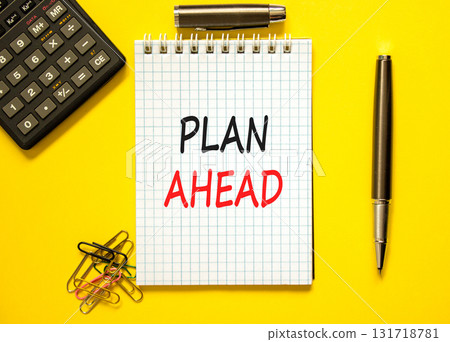 Plan ahead symbol. Concept word Plan ahead on beautiful white note. Black calculator. Black pen. Beautiful yellow paper background. Business plan ahead concept. Copy space. 131718781