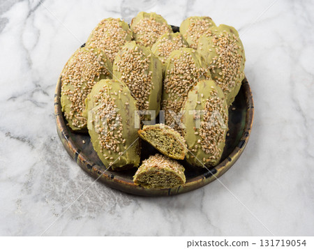 Matcha madeleine cookies with white chocolate frosting on marble background Matcha madeleine cookies with white chocolate frosting on marble background 131719054