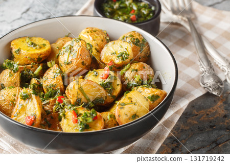 roasted chimichurri potatoes are a great side dish all year round closeup on the plat. Horizontal 131719242