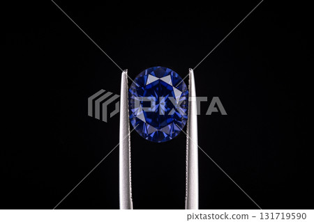 A blue diamond is on a white metal object A blue diamond is on a white metal object 131719590