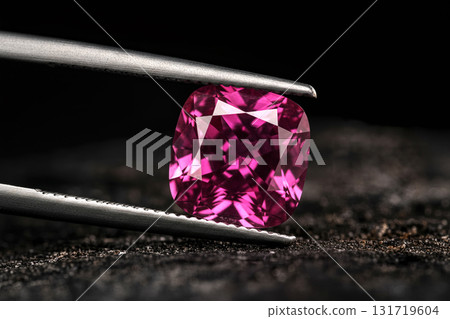 A pink gemstone is displayed in a jeweler's display case A pink gemstone is displayed in a jeweler's display case 131719604