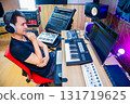 asian male music producer, sound engineer, composer, musician. artist enjoy listening his song in home studio. 131719625