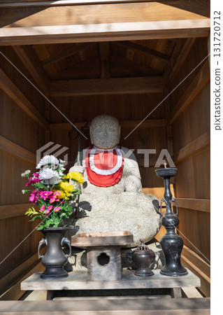 A cute Jizo statue that is loved by the common people and watches over the area. 131720712