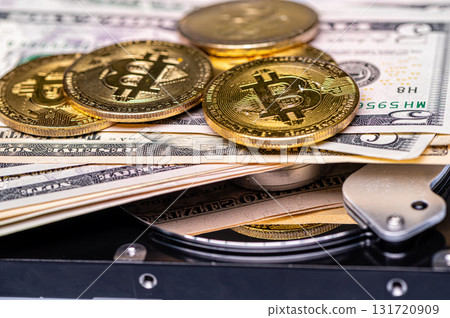 Bitcoin BTC coins, open hard drive and dollar bills, digital payment system concept Bitcoin BTC coins, open hard drive and dollar bills, digital payment system concept 131720909
