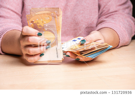 business, finance, saving, banking and people concept - close-up of woman hands counting euro money business, finance, saving, banking and people concept - close-up of woman hands counting euro money 131720936