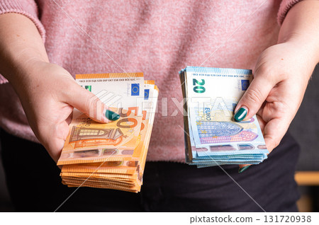 business, finance, saving, banking and people concept - close-up of woman hands counting euro money business, finance, saving, banking and people concept - close-up of woman hands counting euro money 131720938
