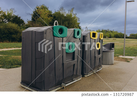 Modern recycling station with separate containers for waste sorting and environmental protection. Concept of sustainability and responsible consumption Modern recycling station with separate containers for waste sorting and environmental protection. Concept of sustainability and responsible consumption 131720987