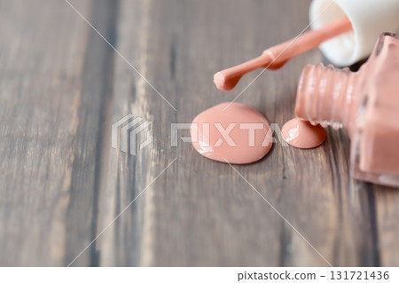 Beige-pink nail polish spilled from a container Beige-pink nail polish spilled from a container 131721436