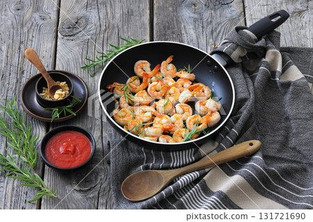 rosemary and garlic seared shrimps in a skillet 131721690
