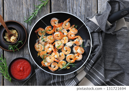 rosemary and garlic seared shrimps in a skillet 131721694