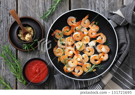 rosemary and garlic seared shrimps in a skillet 131721695